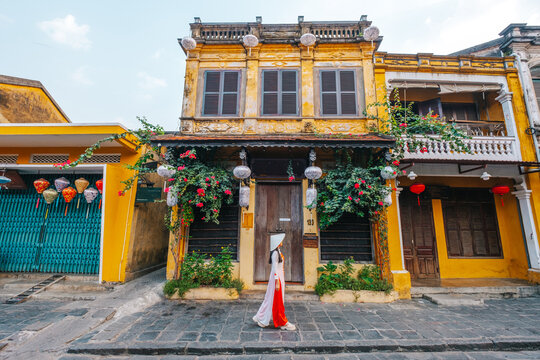 Asian woman wearing vietnam  traditional culture  walking around at Hoi An ancient town,Hoi an city in Vietnam.
