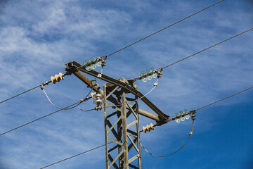 Electricity Pylon Against Clear Blue Sky Background