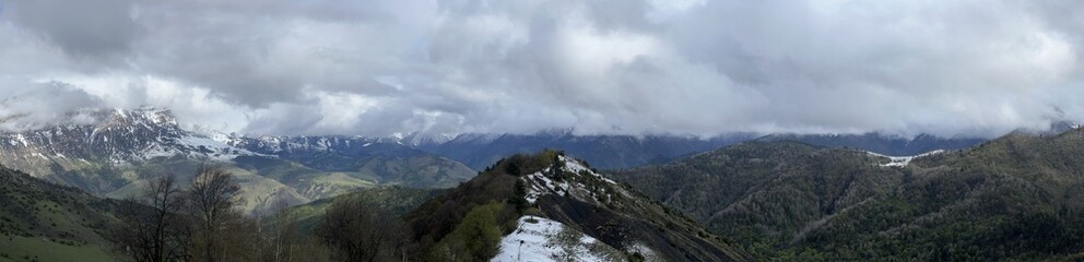 Tseylomsky pass in Ingushetia. A trip uphill to the Tsei Loam pass on a cloudy spring day. Panorama...