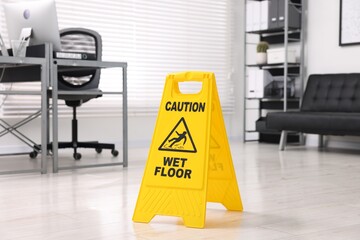 Cleaning service. Wet floor sign in office