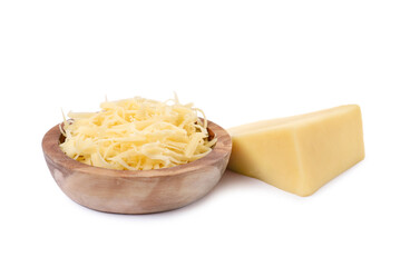 Grated cheese in bowl and piece of one isolated on white