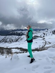 A woman on the background of the Ceylomsky pass in Ingushetia. A trip uphill to the Tsei Lum pass...