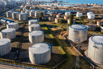 Aerial view of oil tanks at oil refinery. Gas and oil steel storage containers. Tank farm storage chemical petroleum petrochemical refinery product at oil terminal. Petrol industrial plant