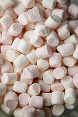 Close-up photo of a pile of pieces of pink marshmallow marshmallow scattered