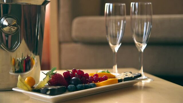 Appetizers, Ice Tray and Two Empty Champagne Glasses on the Table. Preparations for the Romantic Evening Has Been Made.