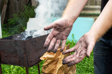 Dirty black hands covered in soot closeup