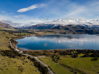 Wanaka, New Zealand: Aerial of the Glendhu Bay and road by lake Wanaka with the snow covered Mt...