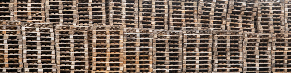 Large stacks of used pallets outside