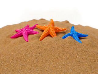 Plastic starfish in sand pile isolated on transparent background