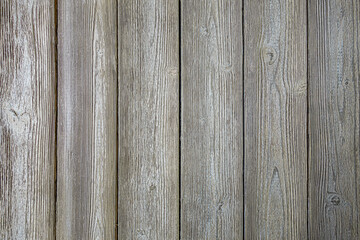 abstract background of an old shabby painted light wooden fence texture close up