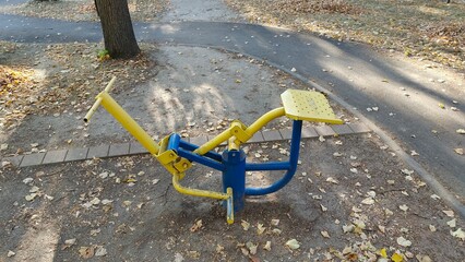 In the city park, various metal exercise equipment for general use has been installed on the...