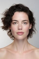 Photo of a young woman for a beauty magazine with fresh, clear skin against a white background