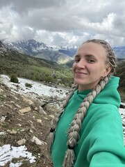 A woman on the background of the Ceylomsky pass in Ingushetia. A trip uphill to the Tsei Lum pass...