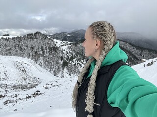 A woman on the background of the Ceylomsky pass in Ingushetia. A trip uphill to the Tsei Lum pass...