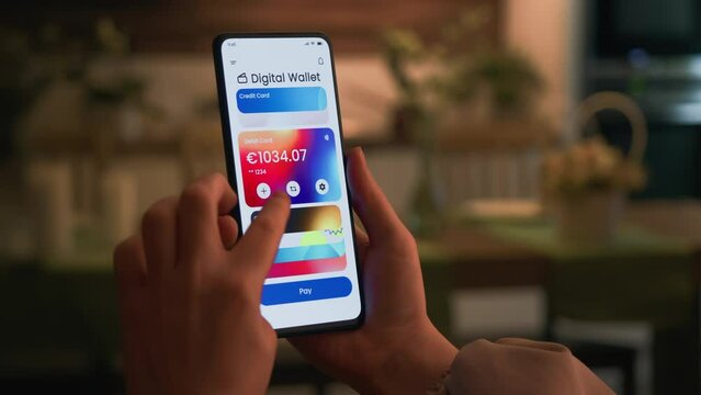 Paying online with a credit card using digital wallet on the smartphone. Choosing from different credit cards for contactless payment.