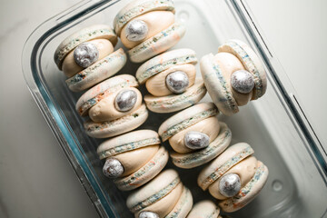 Top view close-up of rectangular glass container with beautiful shell-like macaroons
