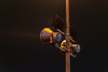 two spotlights on metal pole