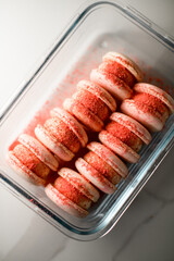 Top view of pink macaroons sprinkled with red powder neatly stacked