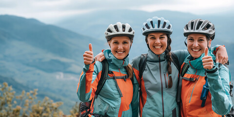 Three female cyclists giving thumbs up on a mountain trail at dusk