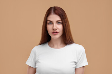 Obraz premium Portrait of beautiful woman with freckles on beige background