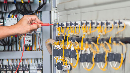 Electrical engineers test electrical installations and electrical wiring by measuring them with a...