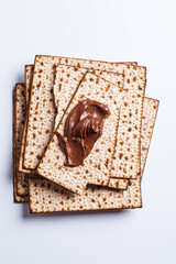 Matza with chocolate spread on white background. Traditional bread for the Jewish holiday of Passover.