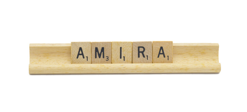 Miami, FL 4-18-24 popular baby girl first name of AMIRA made with square wooden tile English alphabet letters with natural color and grain on a wood rack holder isolated on white background