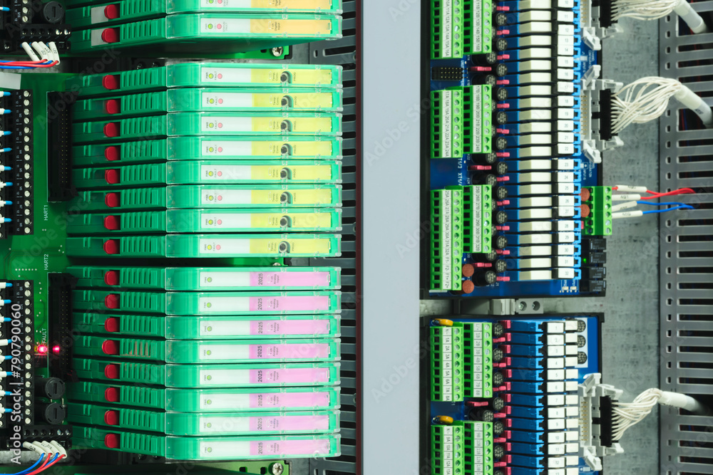 Poster a row of servers with orange connectors on the side. the servers are stacked on top of each other
