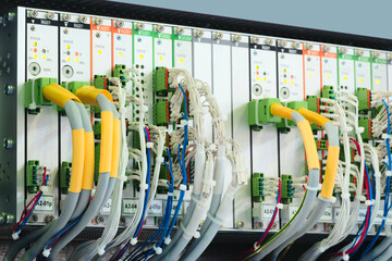 A row of computer cables with a clock on the left side.
