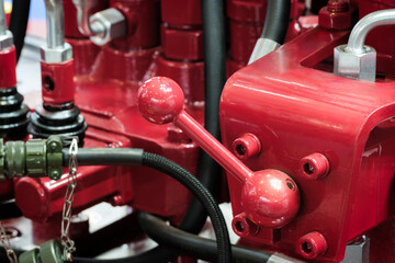 Part of an industrial metal machine with tubes and control levers