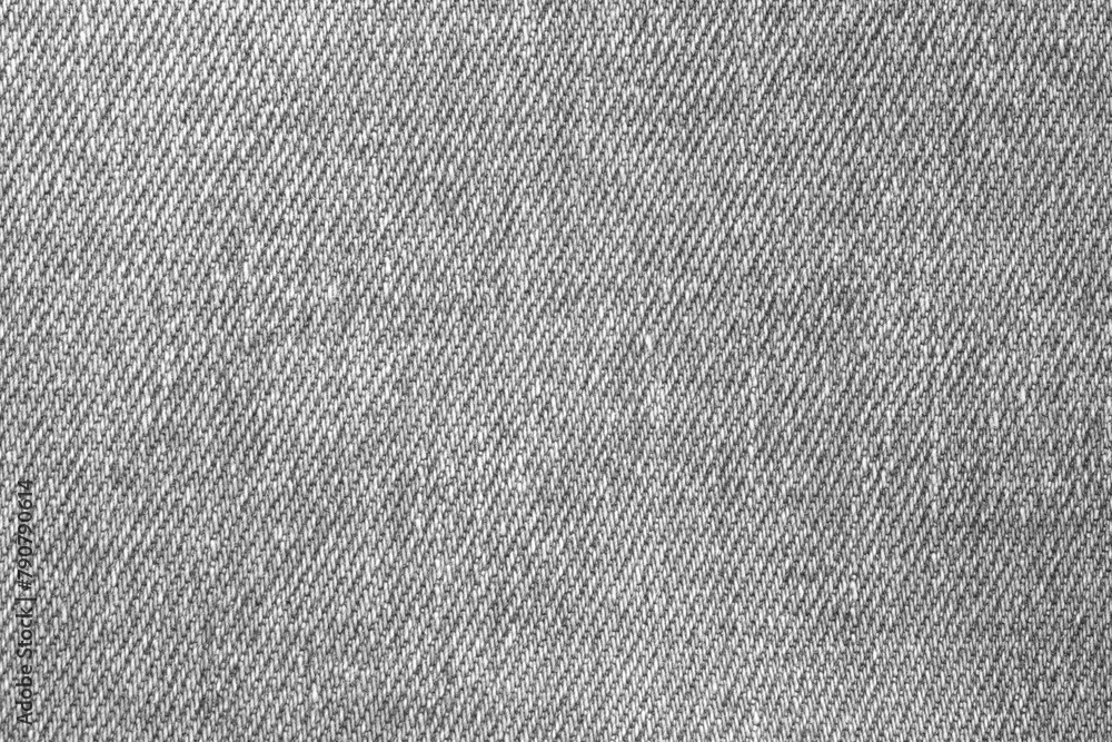 Poster a close up of a piece of denim fabric with a lot of texture. the fabric is a light grey color and ha