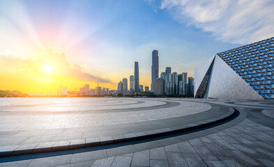 Empty square floors and modern city buildings scenery at sunset in Guangzhou. Panoramic view.
