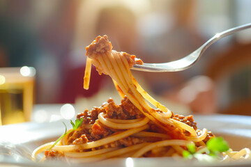 tasty italian spaghetti pasta bolognese with red pesto tomato sauce on a fork, closeup