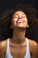 Close-up portrait of an African-American girl against a wall, laughing with her head thrown back, happy. Generative AI.