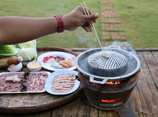 Use chopsticks to pick up the pork pieces and place them on the preheated grill pan. Thai style...