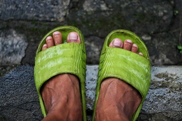 standing on the rocks with green sandals