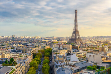 Fototapeta na wymiar Aerial view of Paris with Eiffel Tower and Champs Elysees from the roof of the Triumphal Arch. Panoramic sunset view of old town of Paris. City skyline. Popular travel destination