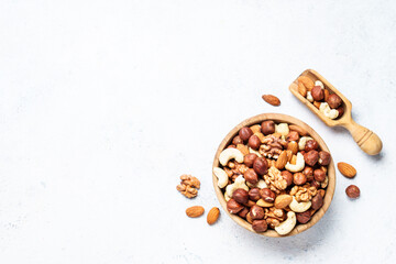 Nuts assortment at white background. Almond, hazelnut, cashew in wooden bowl. Top view - 790809846
