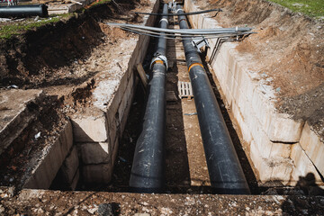 Pipes made of metal are being installed in a trench