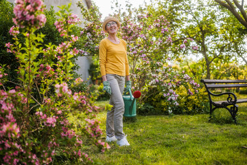 Portrait of happy senior woman gardening.