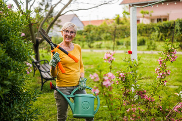 Portrait of happy senior woman gardening.