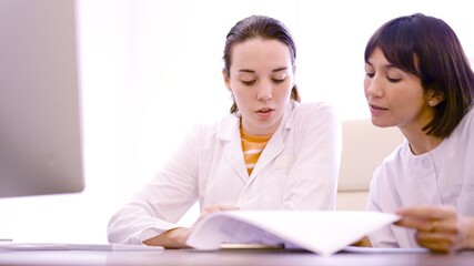 Two doctor consulting a medical inform in the clinic