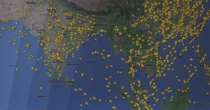 Time lapse of busy air traffic over map on digital screen.

