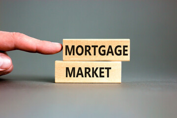 Mortgage market symbol. Concept words Mortgage market on beautiful wooden blocks. Beautiful grey table grey background. Businessman hand. Business mortgage market concept. Copy space.