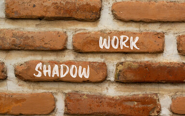 Shadow work psychology symbol. Concept words Shadow work on beautiful brown brick wall. Beautiful brown brick wall background. Psychology shadow work concept. Copy space.