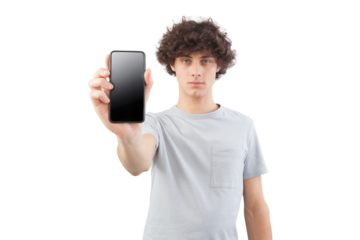 Handsome young man showing the blank screen of his smartphone to the camera, while looking into the camera with his blue eyes, isolated against a white background