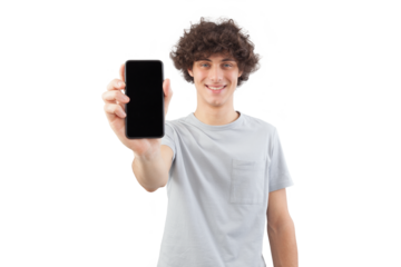 Smiling and handsome, the young man showing the blank screen of his smartphone to the camera, while looking into the camera with his blue eyes, isolated against a white background