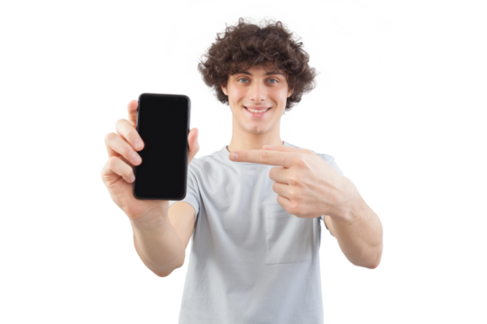 Smiling and handsome, the young man showing the blank screen of his smartphone to the camera pointing display with finger while looking to the camera with his blue eyes, isolated on white background