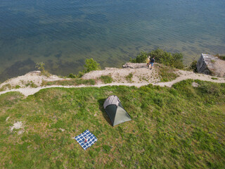 A couple relaxes with a tent and makes a picnic on the shore of the Baltic Sea in Paldiski in...