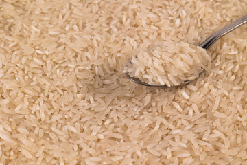 Photography white rice grains with metal spoon